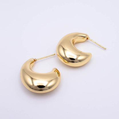 A pair of polished gold crescent-shaped hoop earrings with post backs, displayed on a clean white background.
