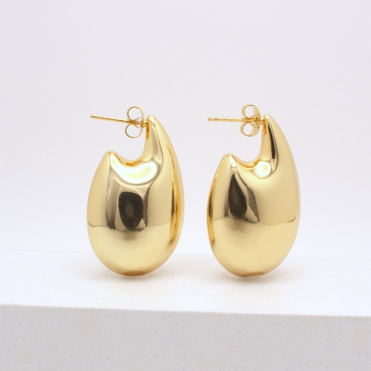 Pair of gold hoop earrings on a white background