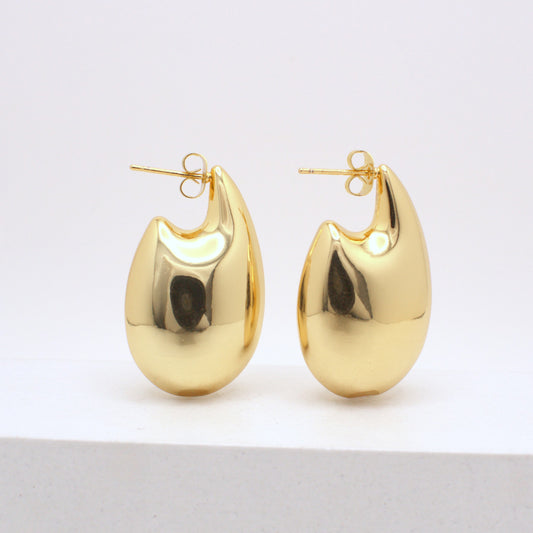 Pair of gold hoop earrings on a white background
