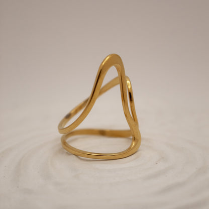 Gold ring on a beige background