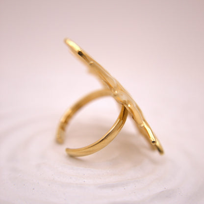 Gold ring on a light pink background