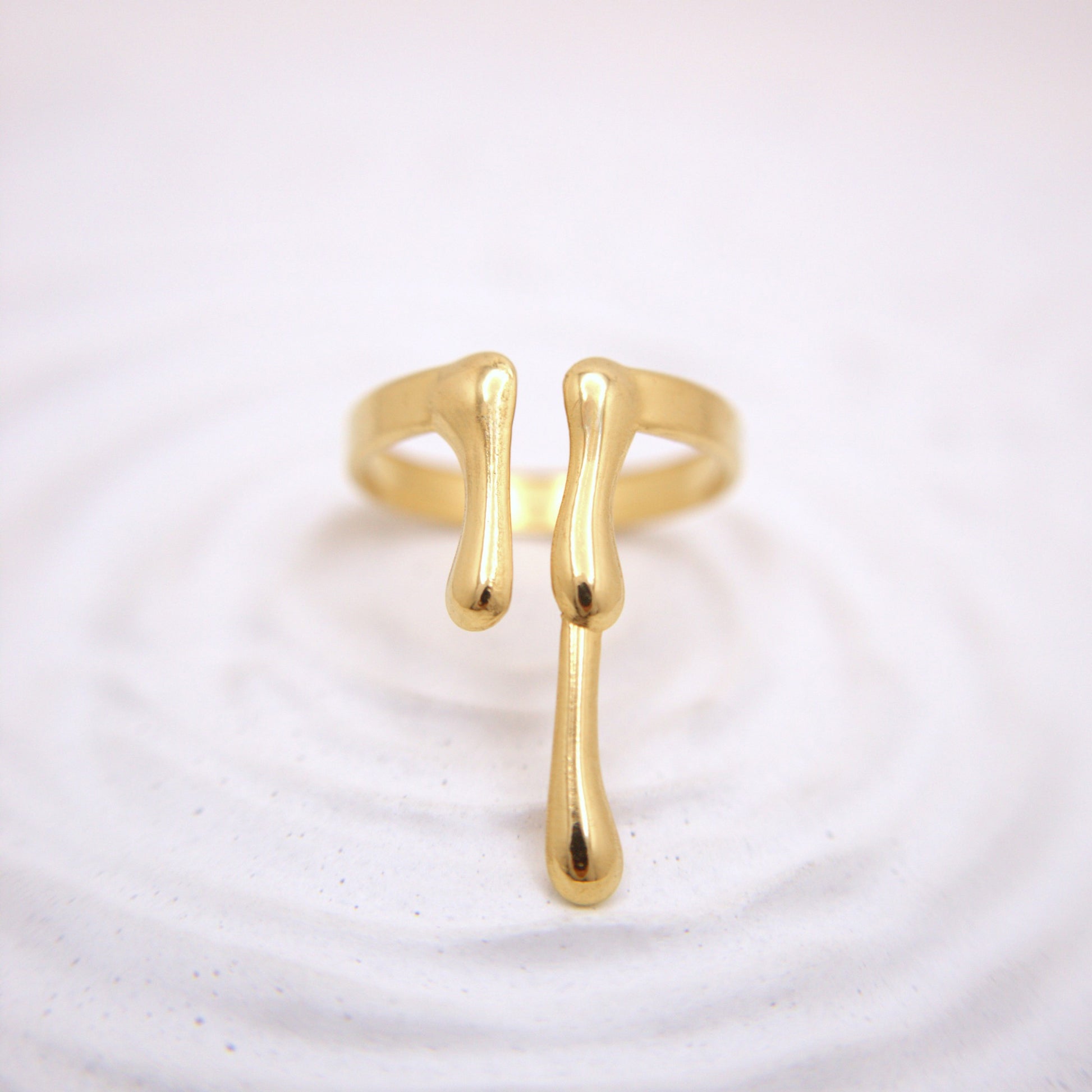 Gold ring with a unique design on a white background