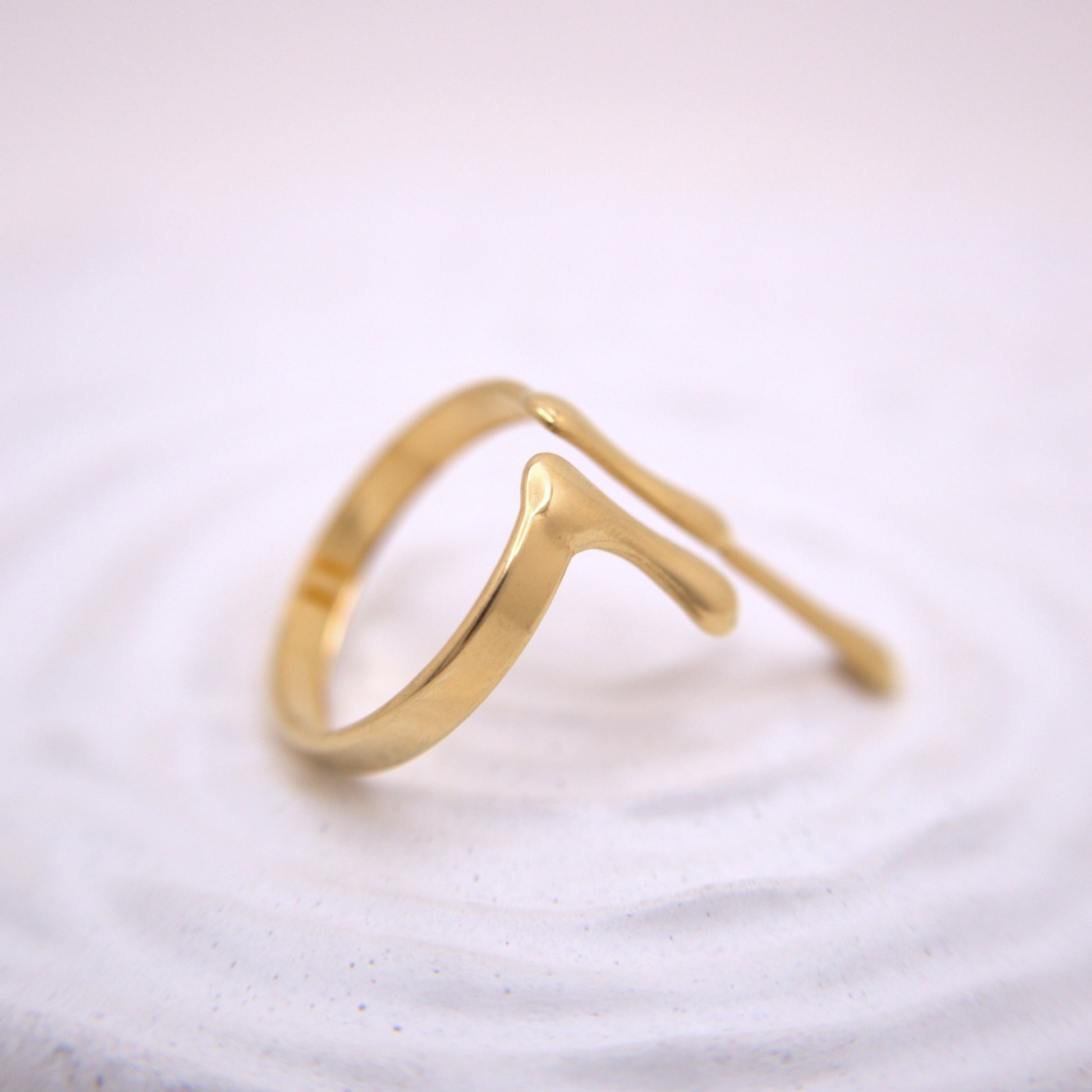 Gold ring on a textured white surface