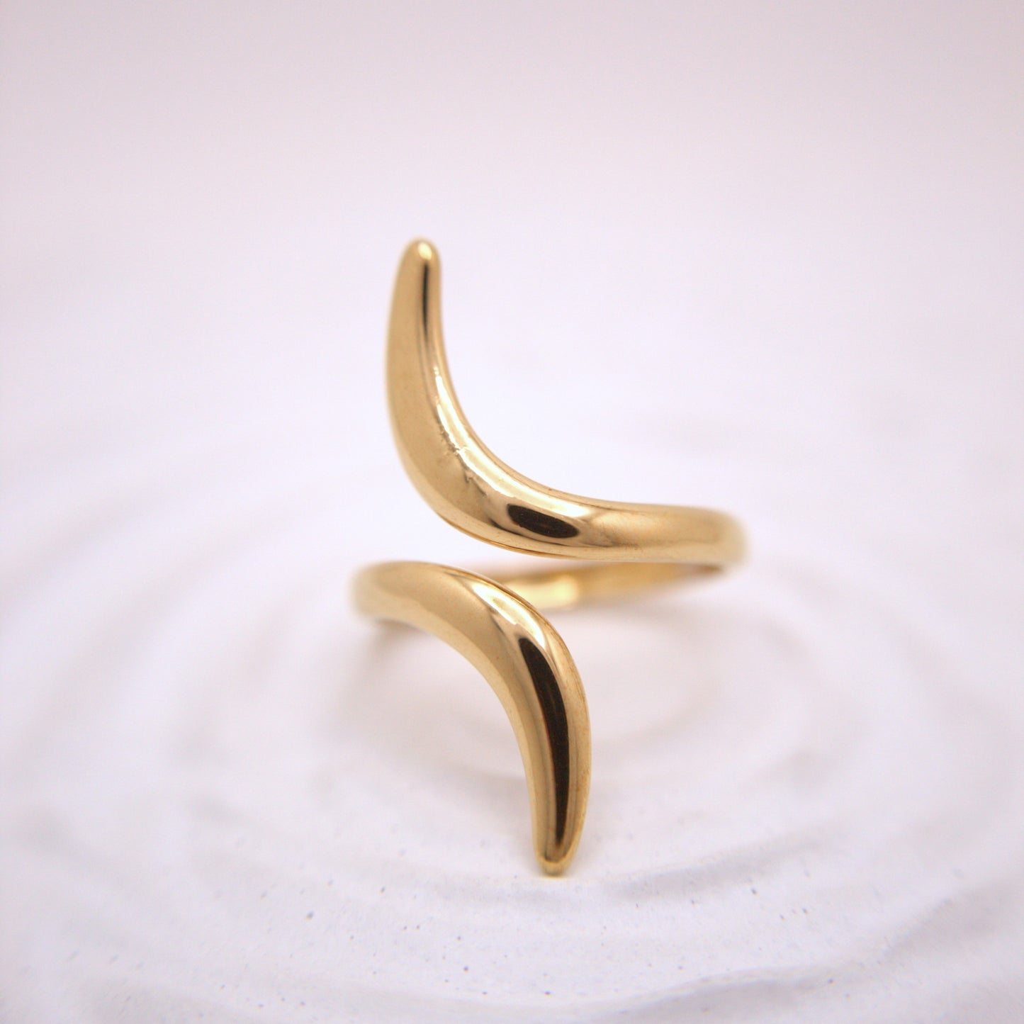Gold ring with a unique design on a white background
