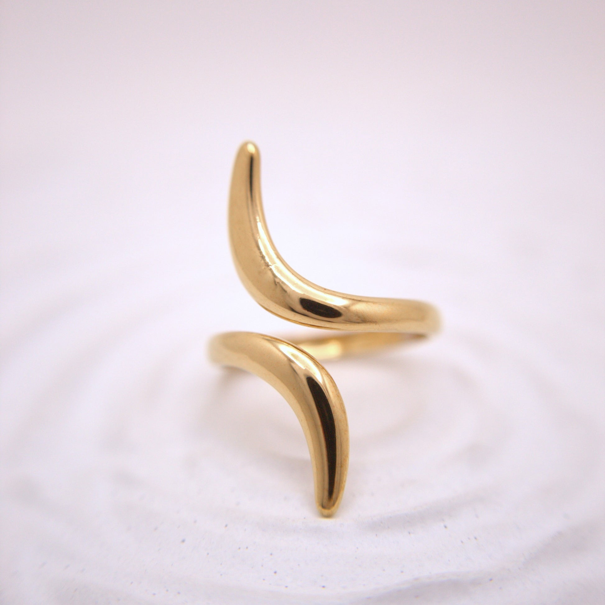 Gold ring with a unique design on a white background