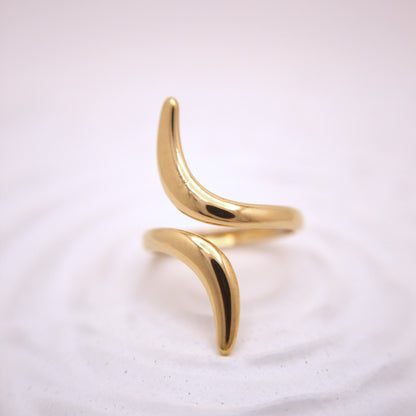 Gold ring with a unique design on a white background