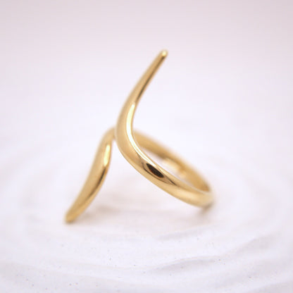 Gold ring with a unique design on a white background