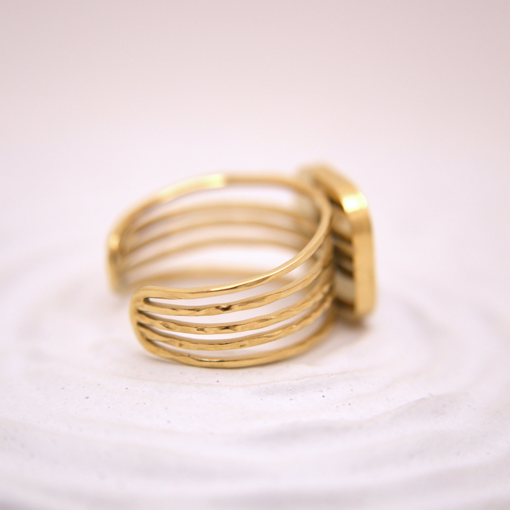 Gold ring on a light pink background