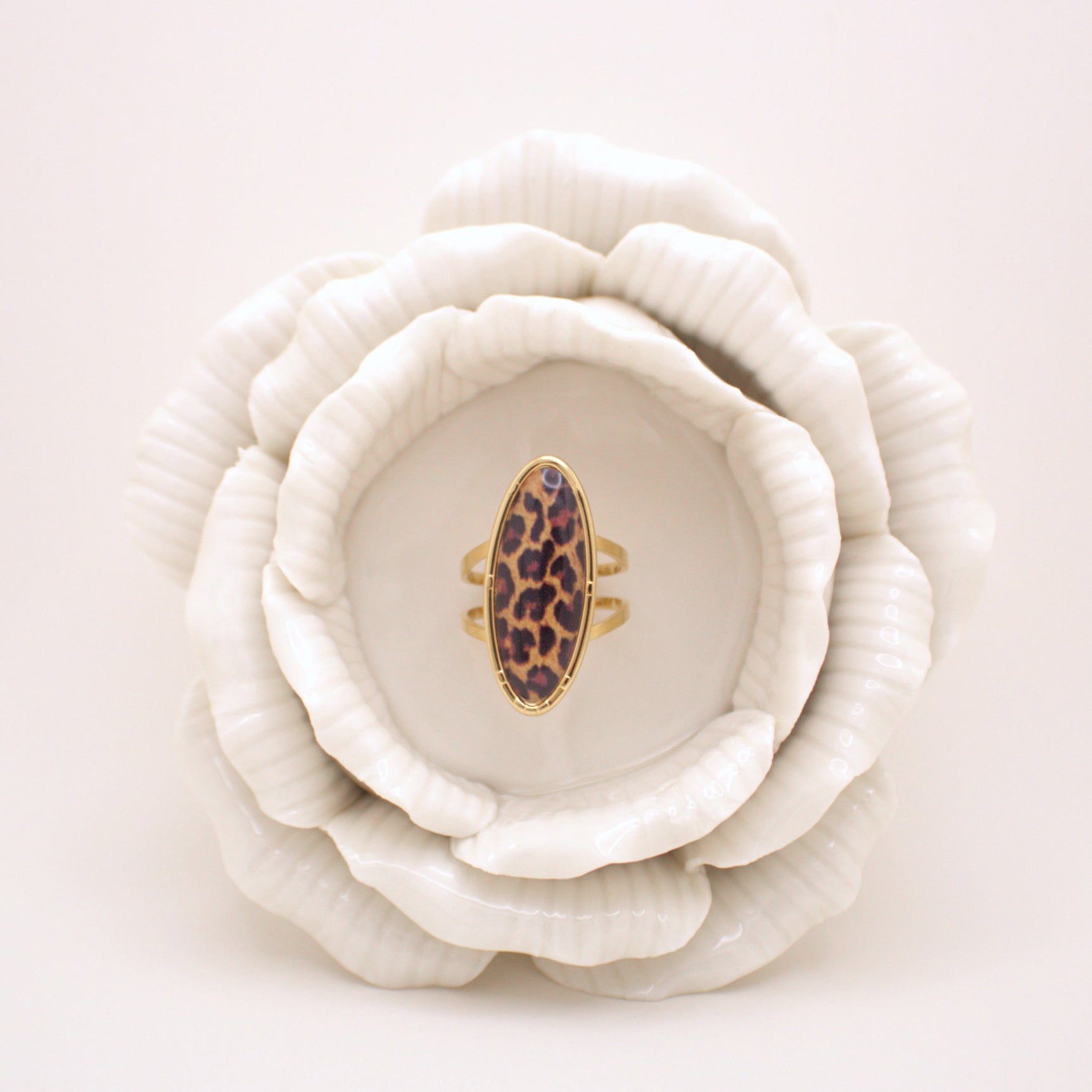 Leopard print ring on a white ceramic flower