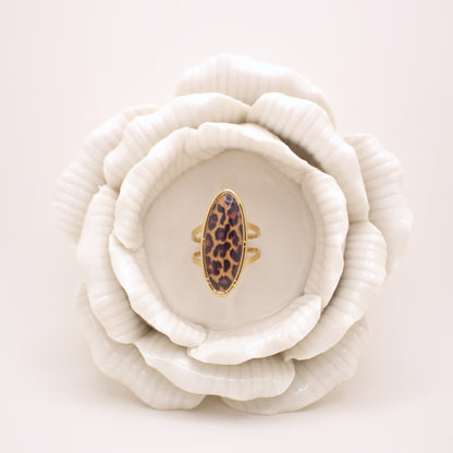 Leopard print ring on a white ceramic flower