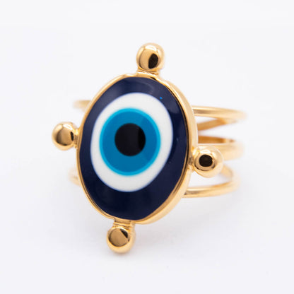 Gold-plated evil eye ring with a blue, white, and black enamel design on a white background.