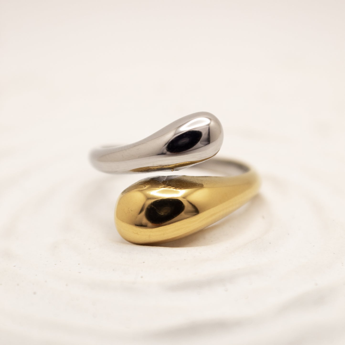 one ring,two tones gold and silver, on a light beige background