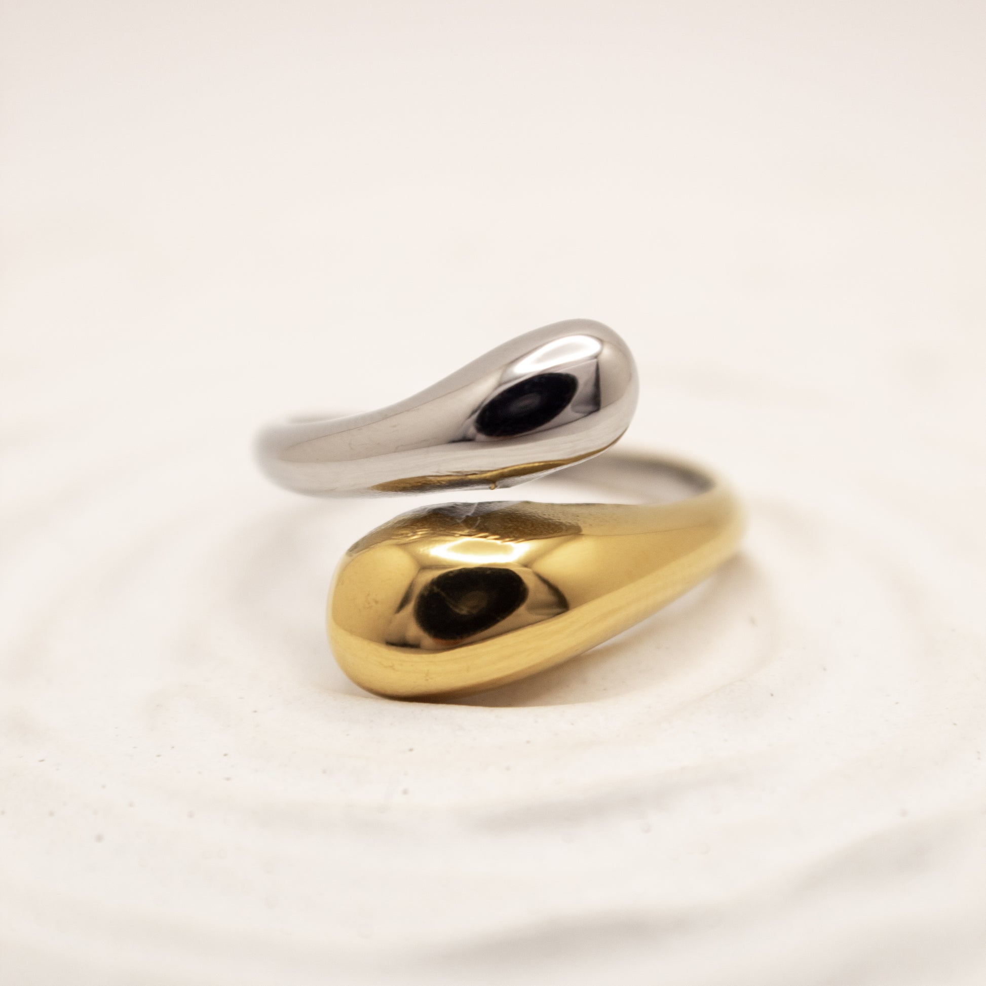 one ring,two tones gold and silver, on a light beige background