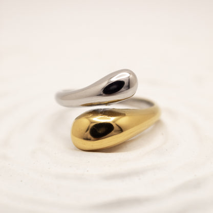 one ring,two tones gold and silver, on a light beige background