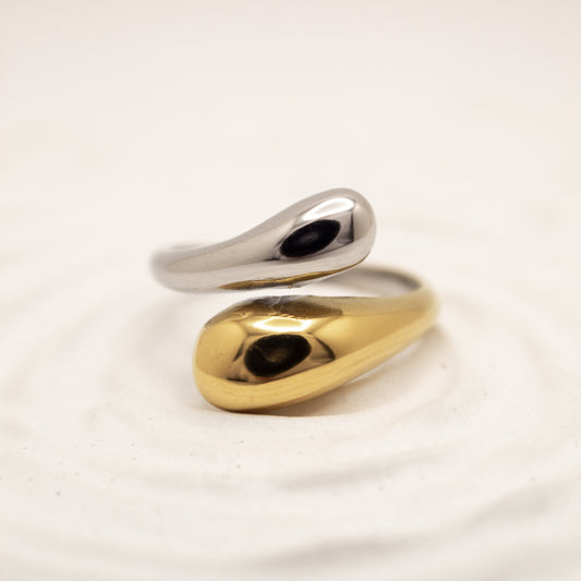 one ring,two tones gold and silver, on a light beige background