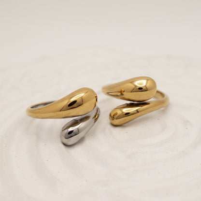 Two gold rings on a light beige background