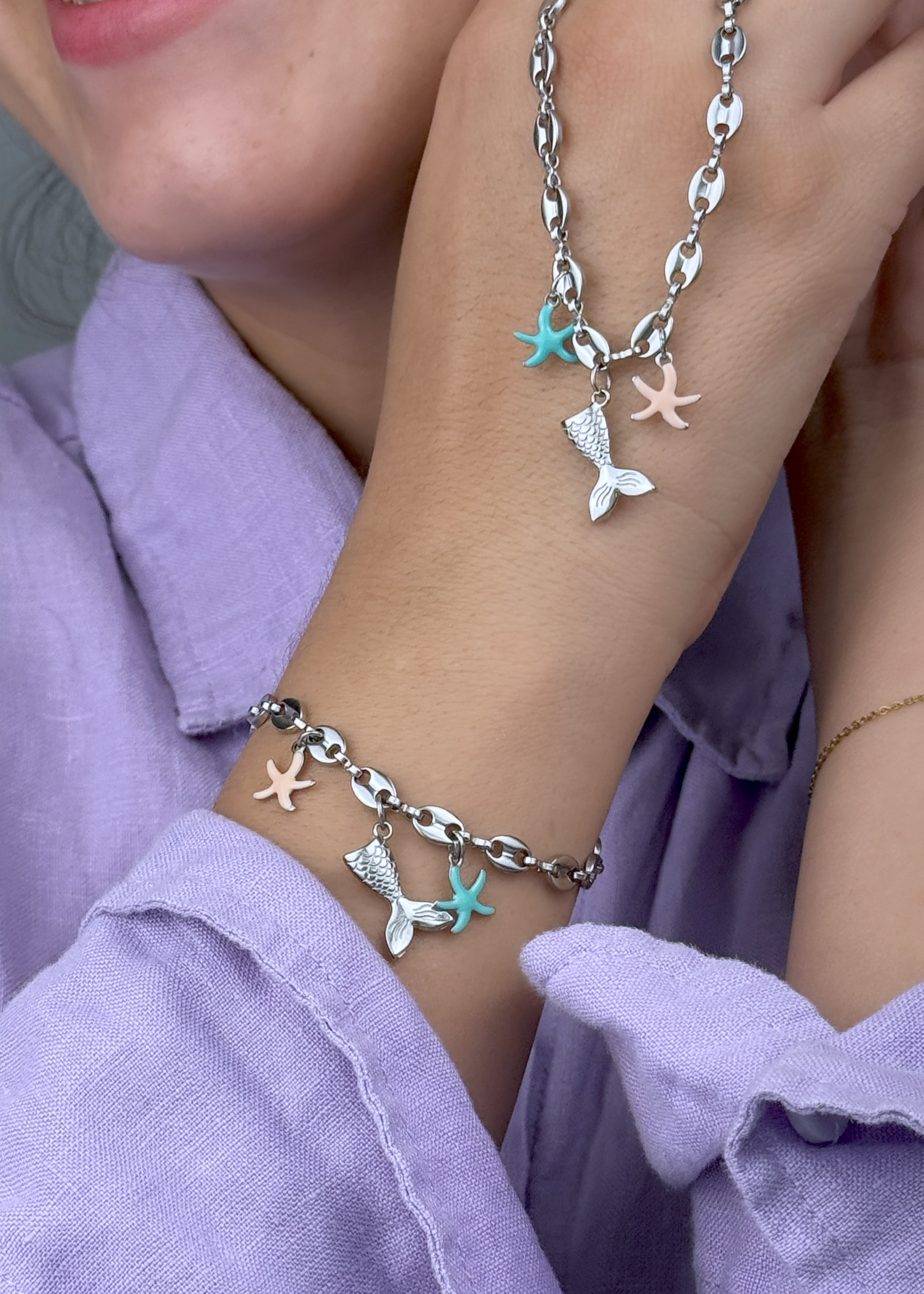 Silver bracelet featuring turquoise and pink enamel starfish with mermaid tail