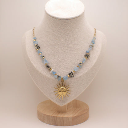 Necklace with a sun pendant on a mannequin bust against a white background