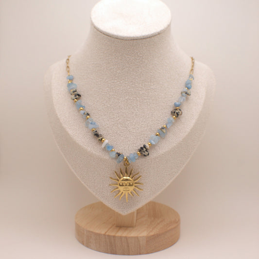 Necklace with a sun pendant on a mannequin bust against a white background