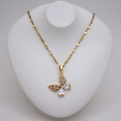 Gold necklace with a butterfly pendant on a white stand