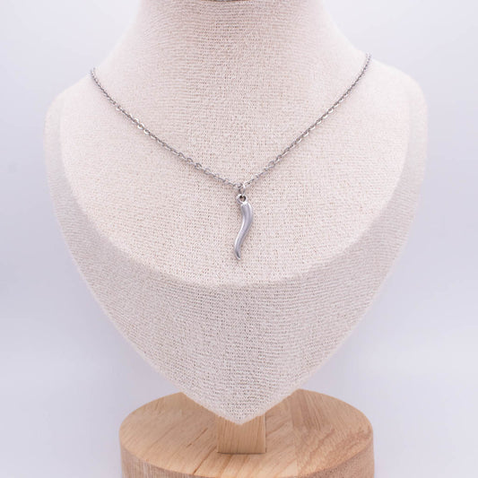 A silver pendant necklace displayed on a cream fabric-covered jewelry bust with a wooden base against a light gray background.