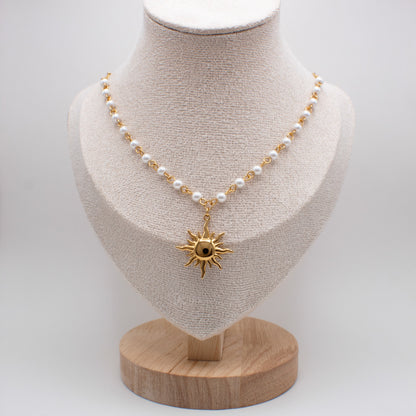 Necklace with a sun pendant on a mannequin bust against a white background