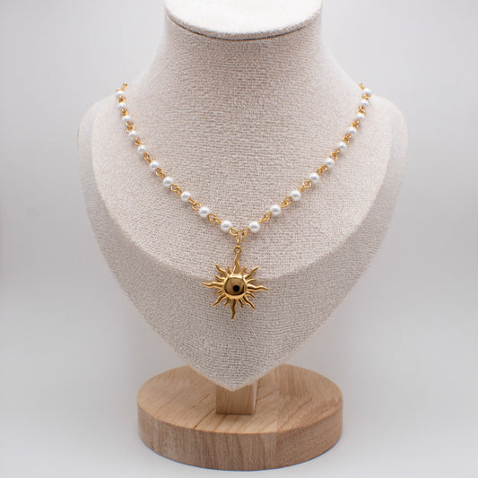 Necklace with a sun pendant on a mannequin bust against a white background