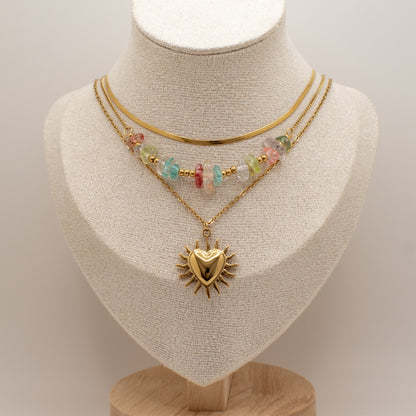 Two necklaces on a mannequin bust with a plain background