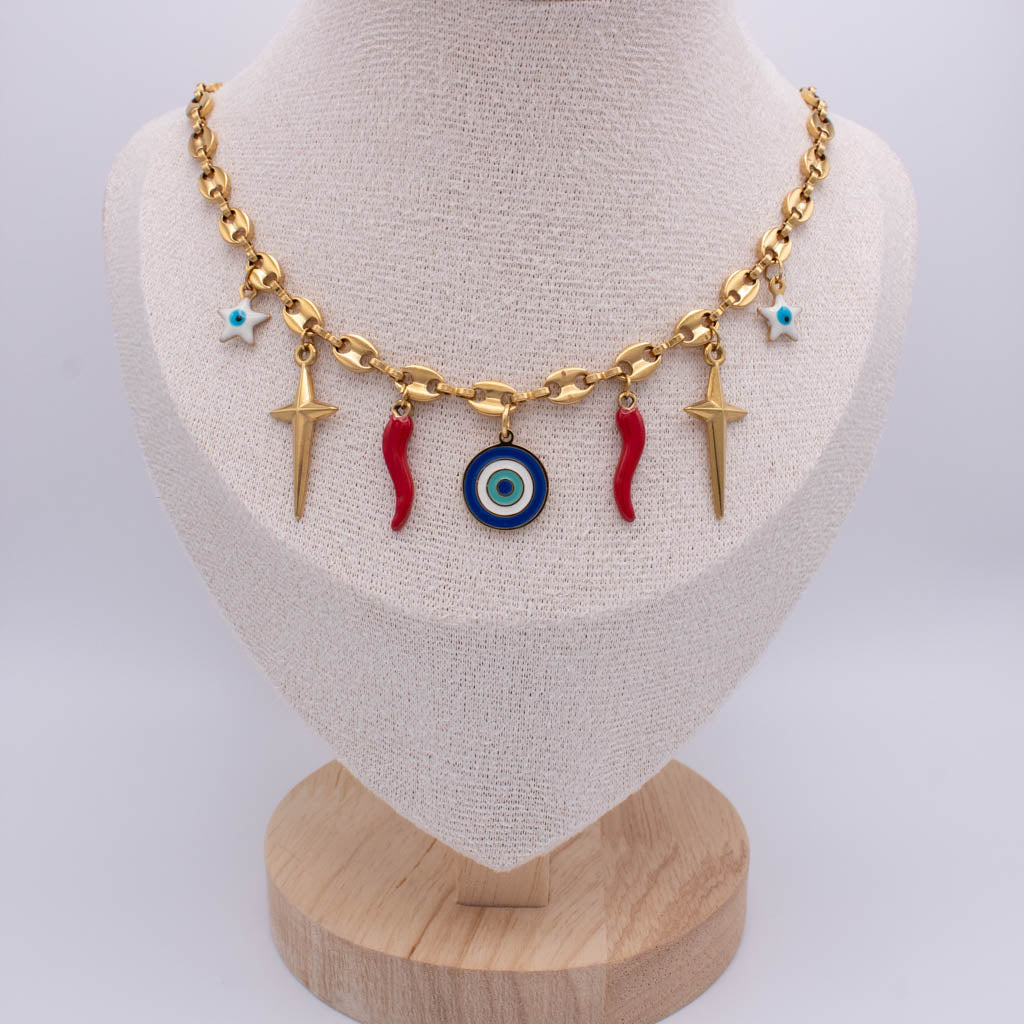 A gold-tone chain necklace displayed on a beige fabric jewelry bust. The necklace features dangling charms including two red italian horn, a blue and white evil eye pendant, two gold-tone starfish, and two small turquoise star charms.