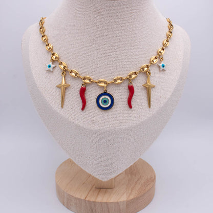 A gold-tone chain necklace displayed on a beige fabric jewelry bust. The necklace features dangling charms including two red italian horn, a blue and white evil eye pendant, two gold-tone starfish, and two small turquoise star charms.
