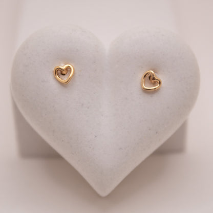 Gold heart stud earrings with high-shine finish by Selva&Co.