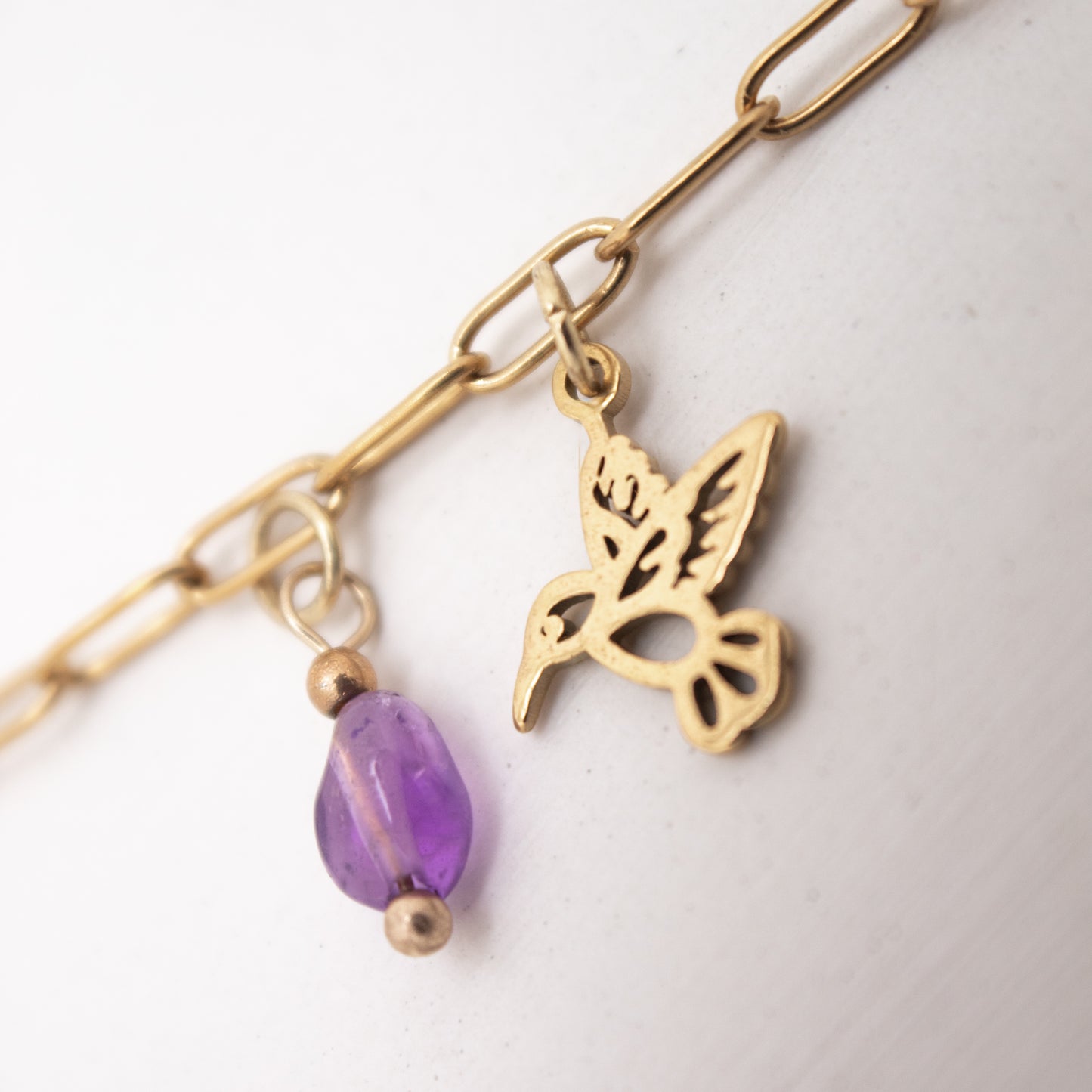 Golden anklet with purple crystal and hummingbird charm