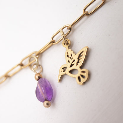 Golden anklet with purple crystal and hummingbird charm