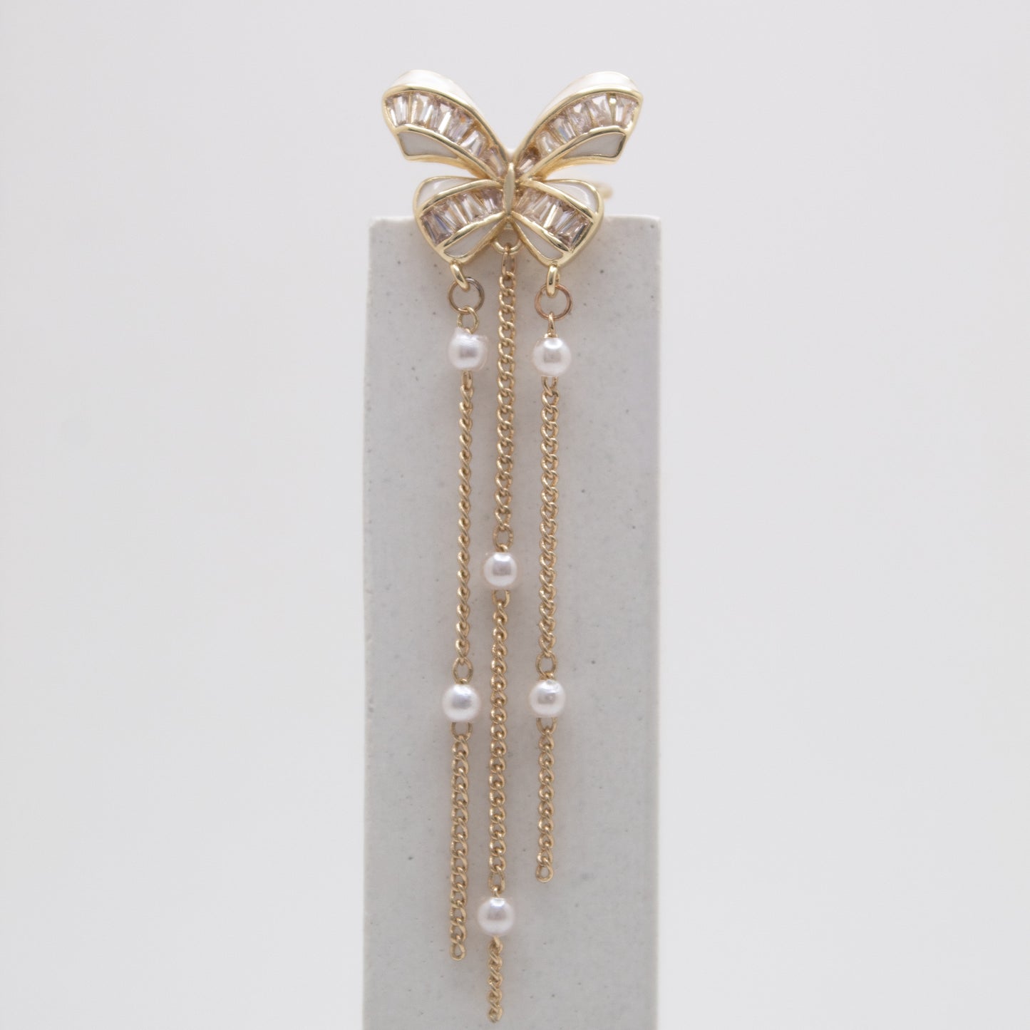 Golden butterfly ear cuff with pearls and chain drops