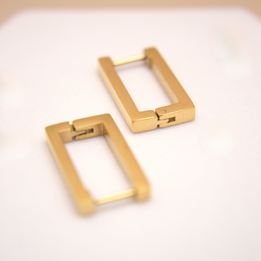 Pair of gold hoop earrings on a light background