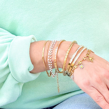 Golden bangle with clear and soft pink crystal line