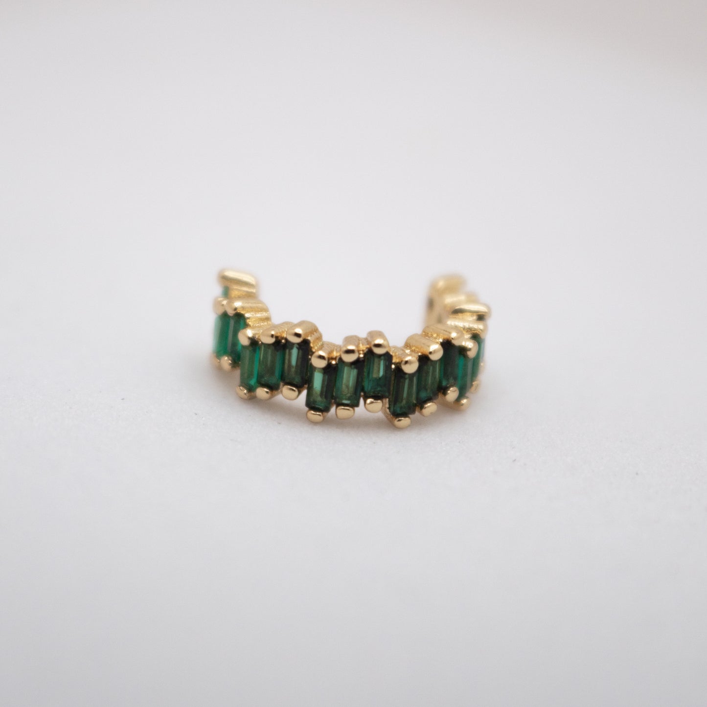Golden ear cuff with green baguette crystals