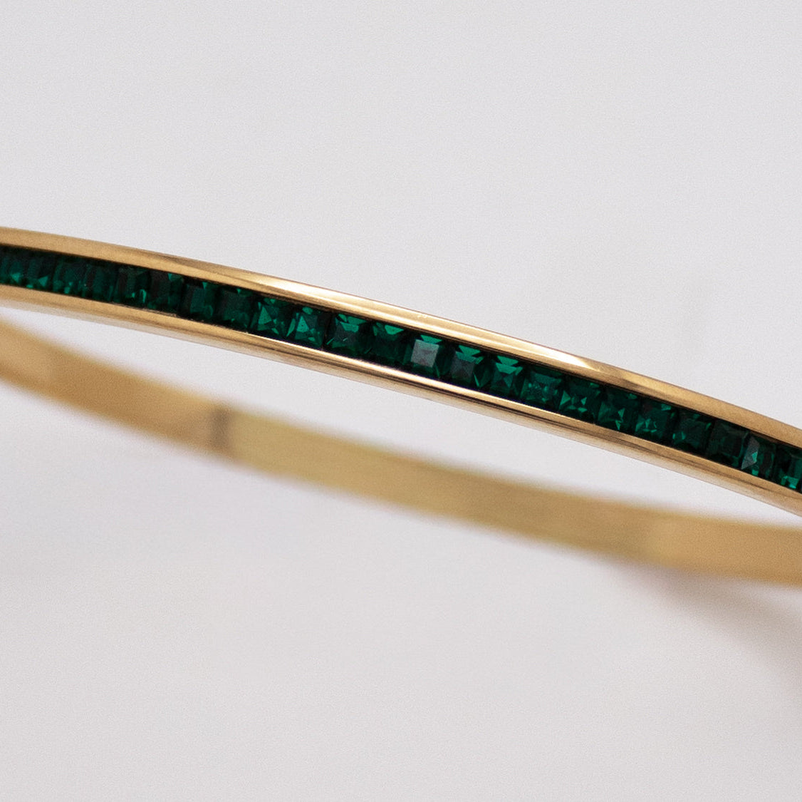 Golden bangle with emerald crystal line in PVD stainless steel