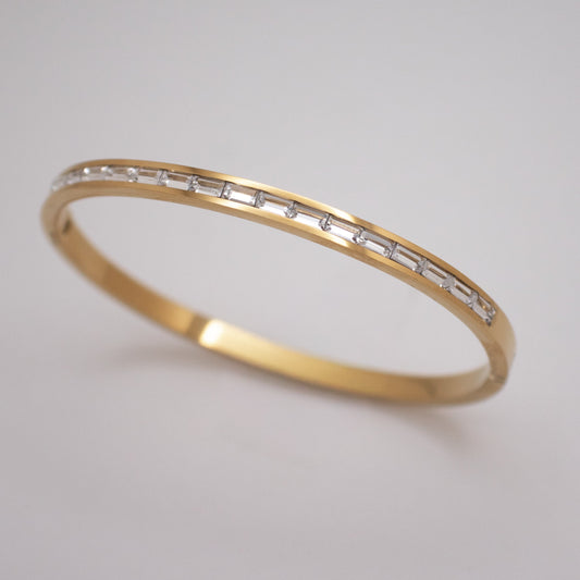 Golden bangle with clear and soft pink crystal line