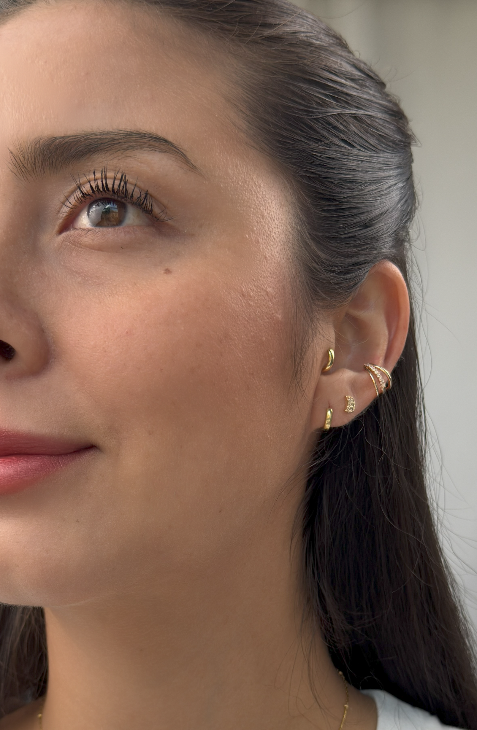 Minimalist crescent moon stud earrings, gold with cubic zirconia for everyday wear.