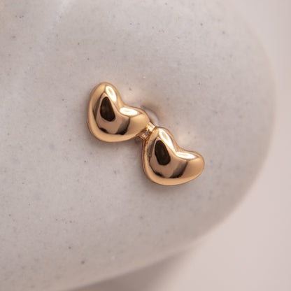 Romantic double heart stud earrings in gold rose finish.