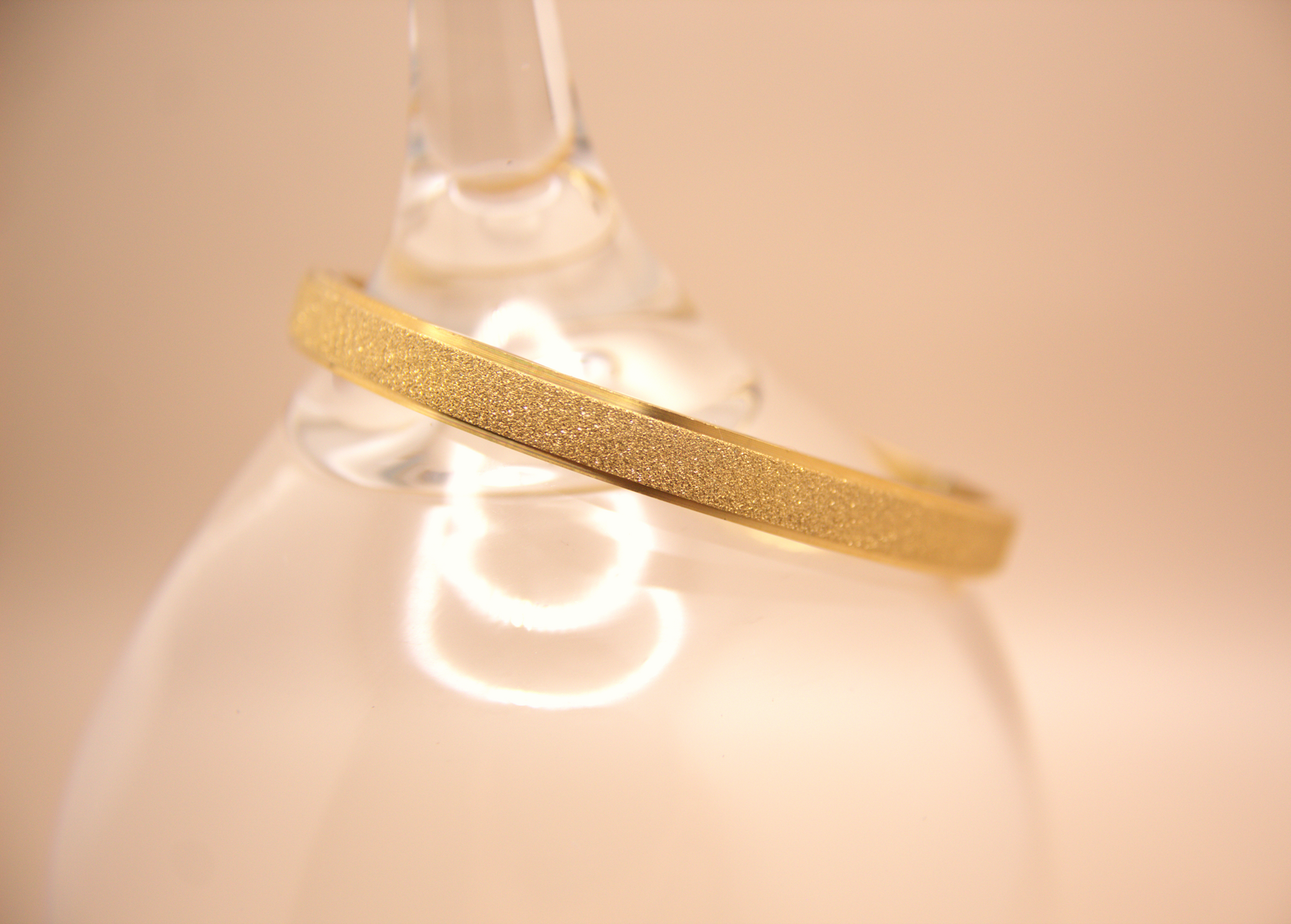 Gold bangle bracelet with sparkly textured finish, PVD stainless steel.