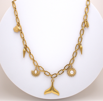 Gold waterproof necklace with sun and shell charms by Selva&Co
