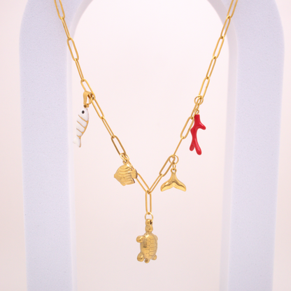 Golden Reef Necklace with turtle, coral, and enamel white fish charms