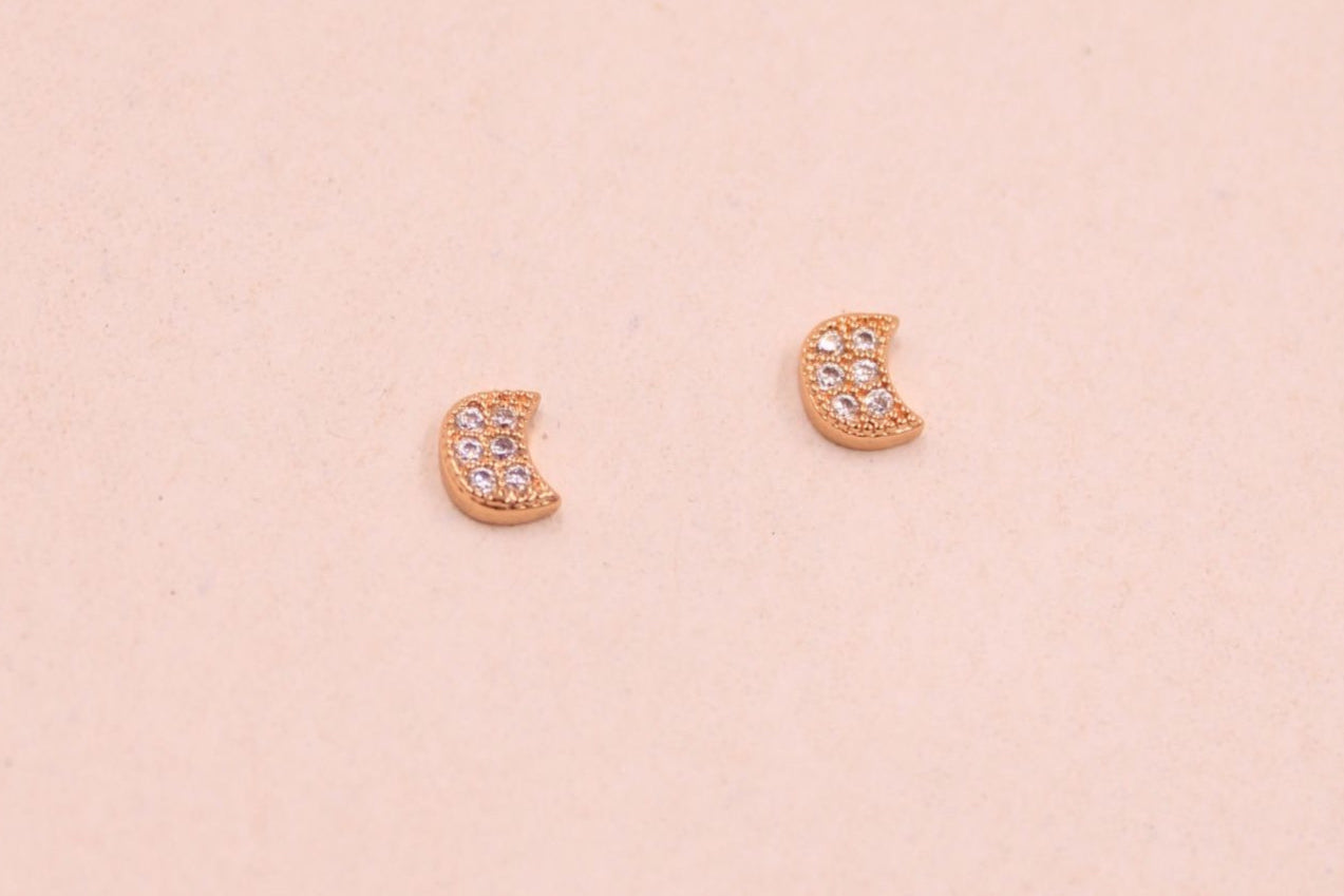 Mini gold moon stud earrings with white cubic zirconia stones, dainty and elegant design.