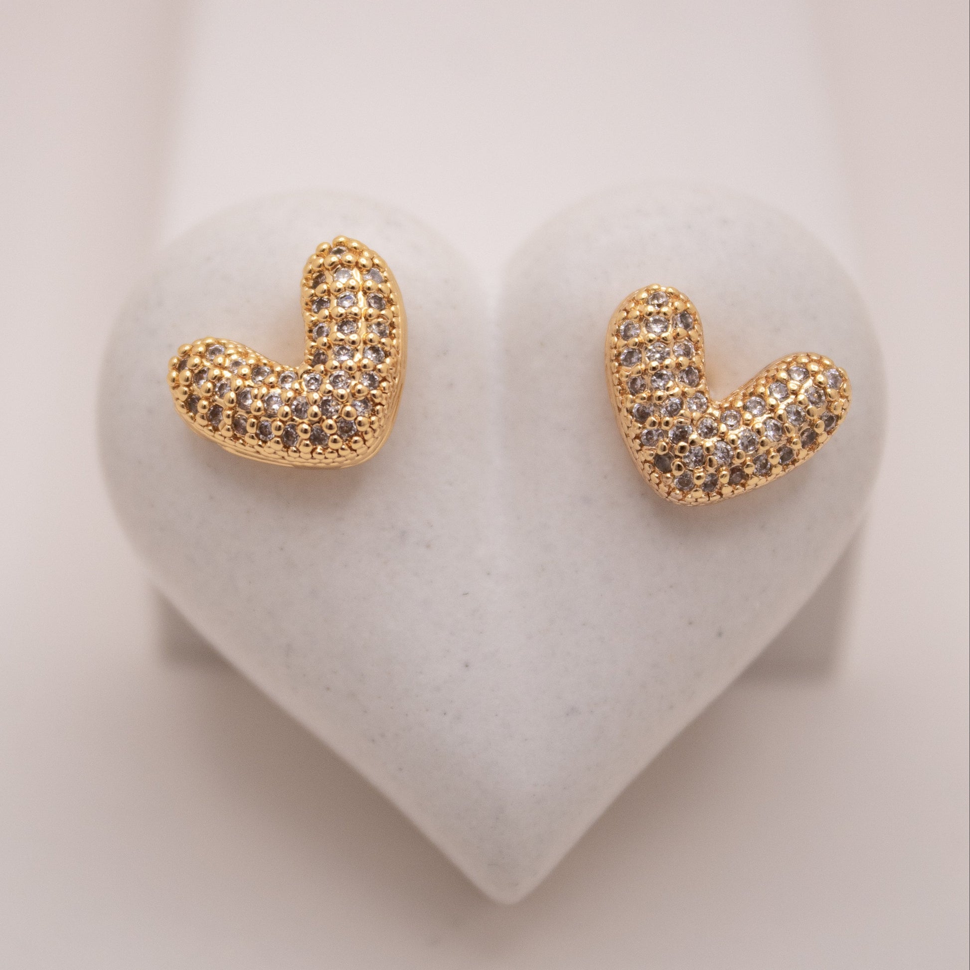 Gold heart stud earrings with high-shine finish by Selva&Co.