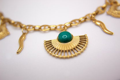 Boho chic gold charm necklace, stainless steel chain with amulet-inspired pendants.