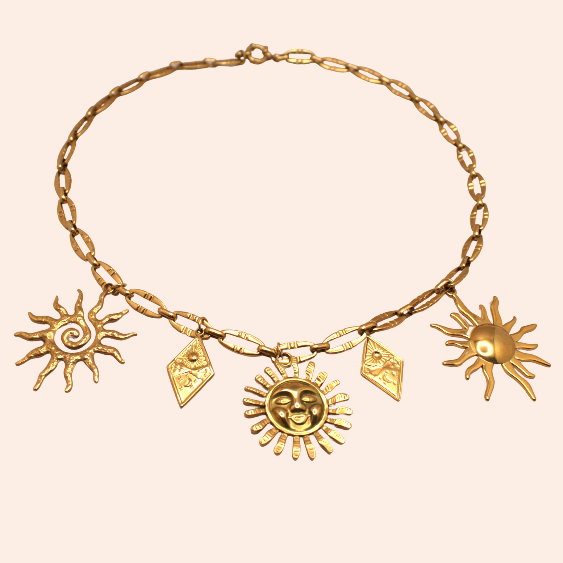 Gold multi-charm necklace with sun-inspired pendants, PVD stainless steel link chain.