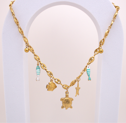 Ocean Breeze Necklace in gold with turtle, starfish, and turquoise fish charms