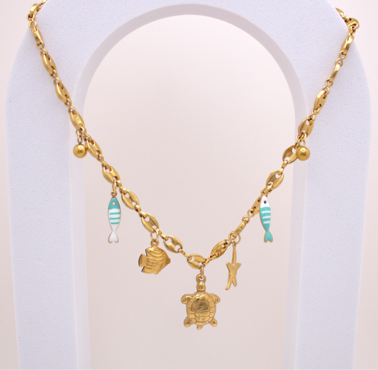 Ocean Breeze Necklace in gold with turtle, starfish, and turquoise fish charms